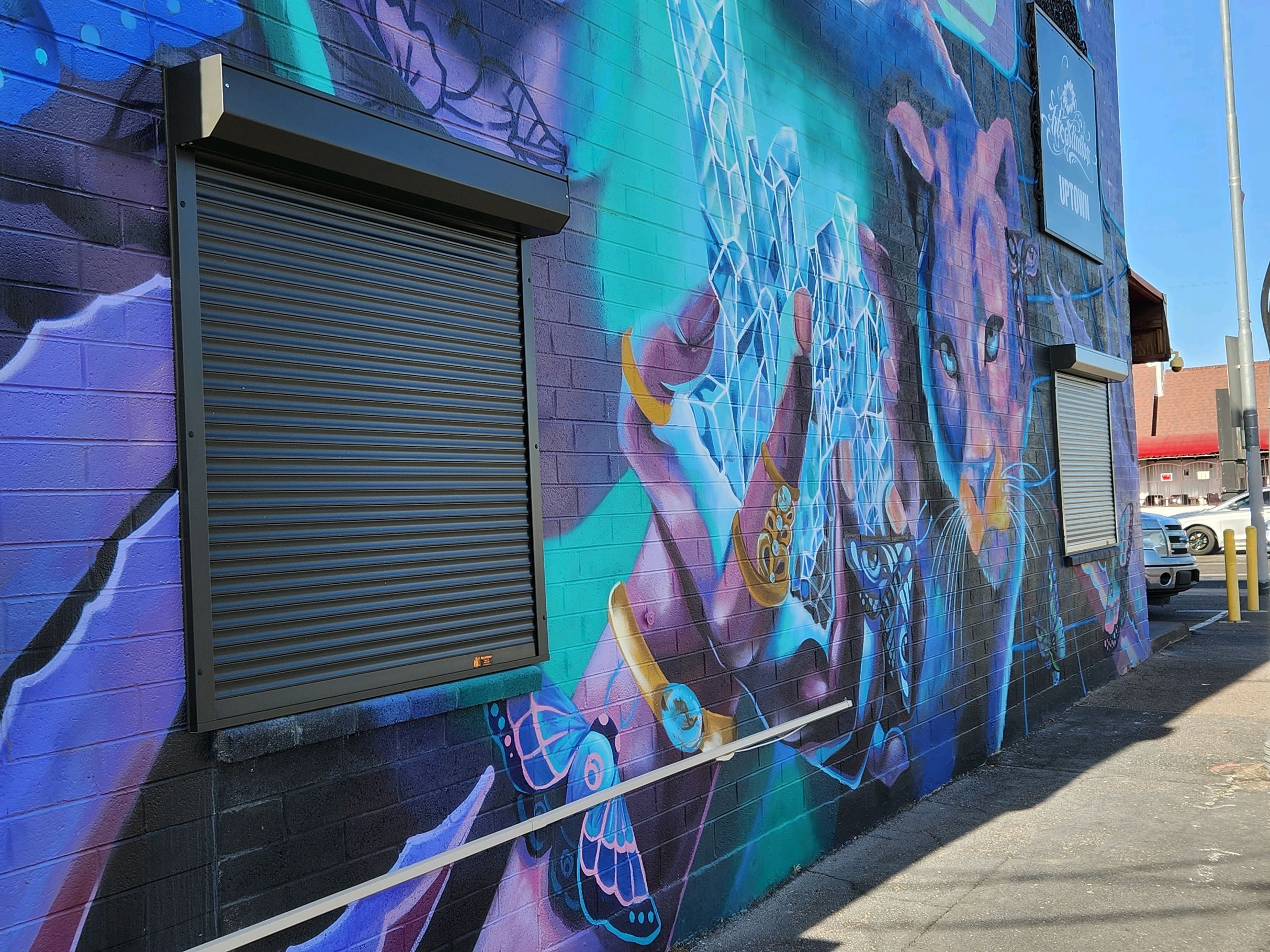 An image exterior rolling shutters outside of a commercial establishment with graffiti