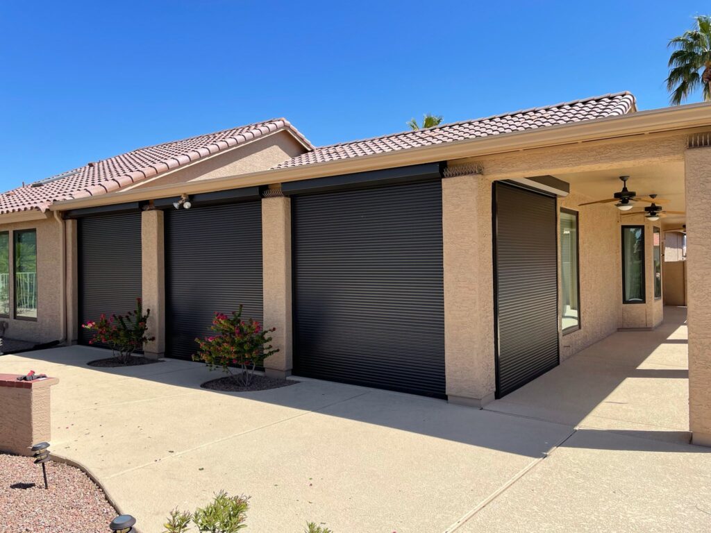 An image showing a home with rolling shutters installed outside its windows