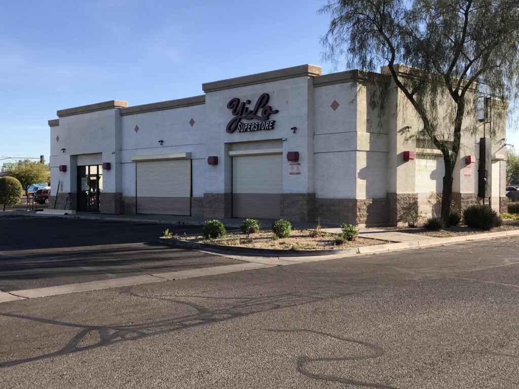 An image showing closed commercial rolling shutters outside a superstore