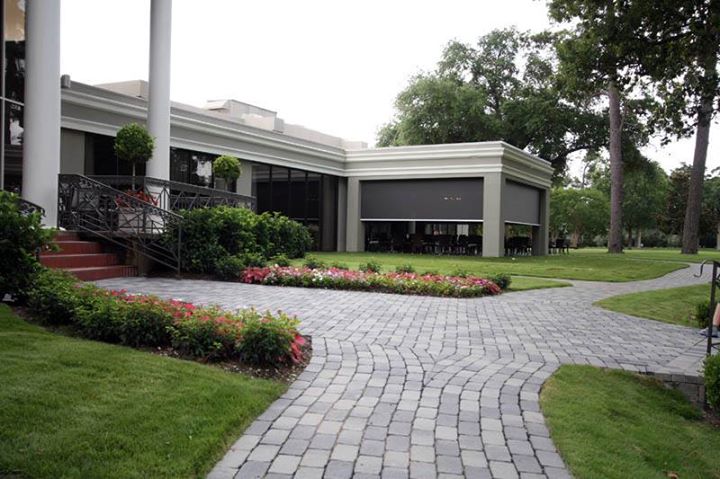Multi-bay motorized retractable patio screens on commercial restaurant outdoor dining