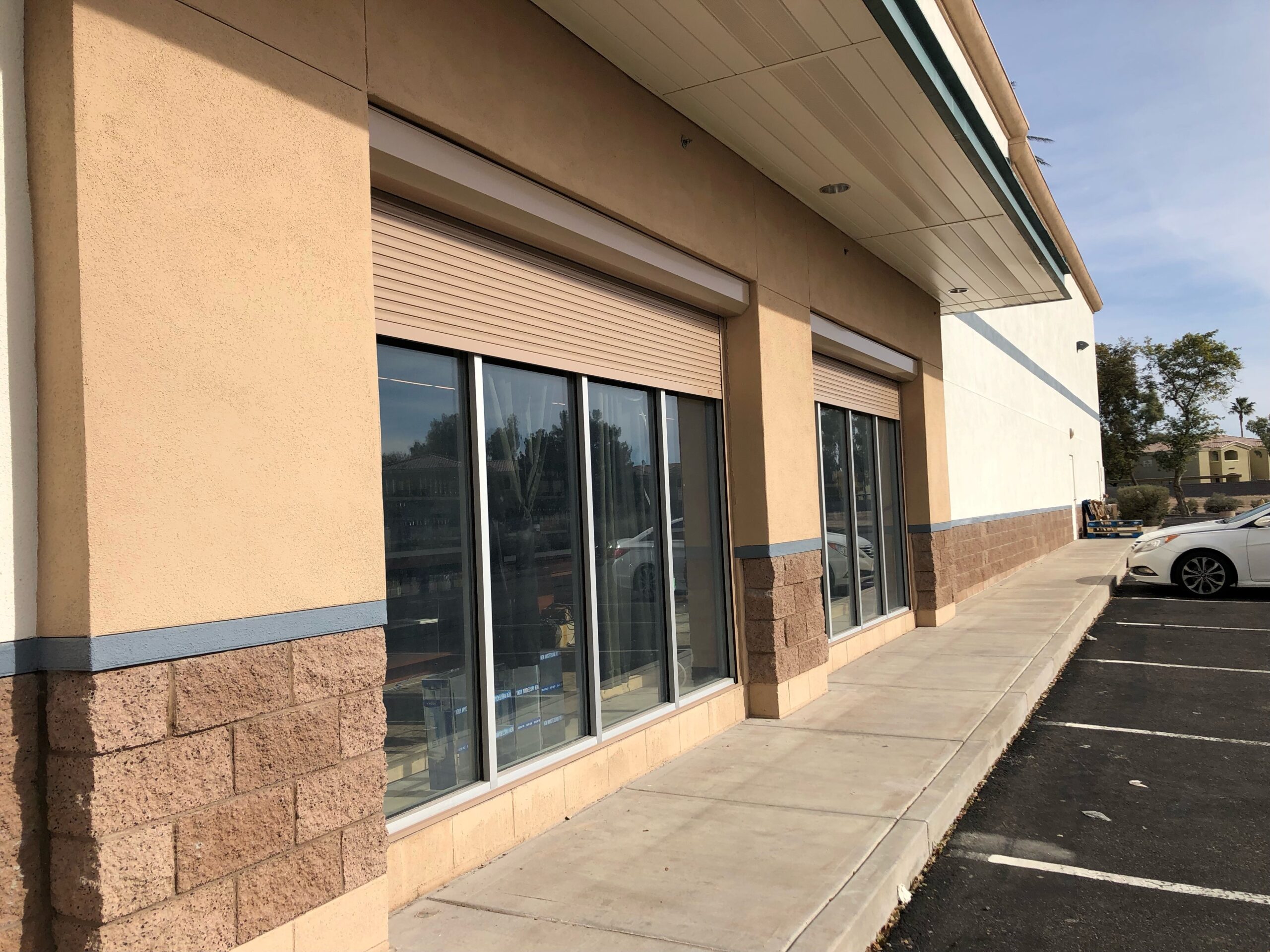 Commercial storefront with rolling security shutters protecting a retail entrance