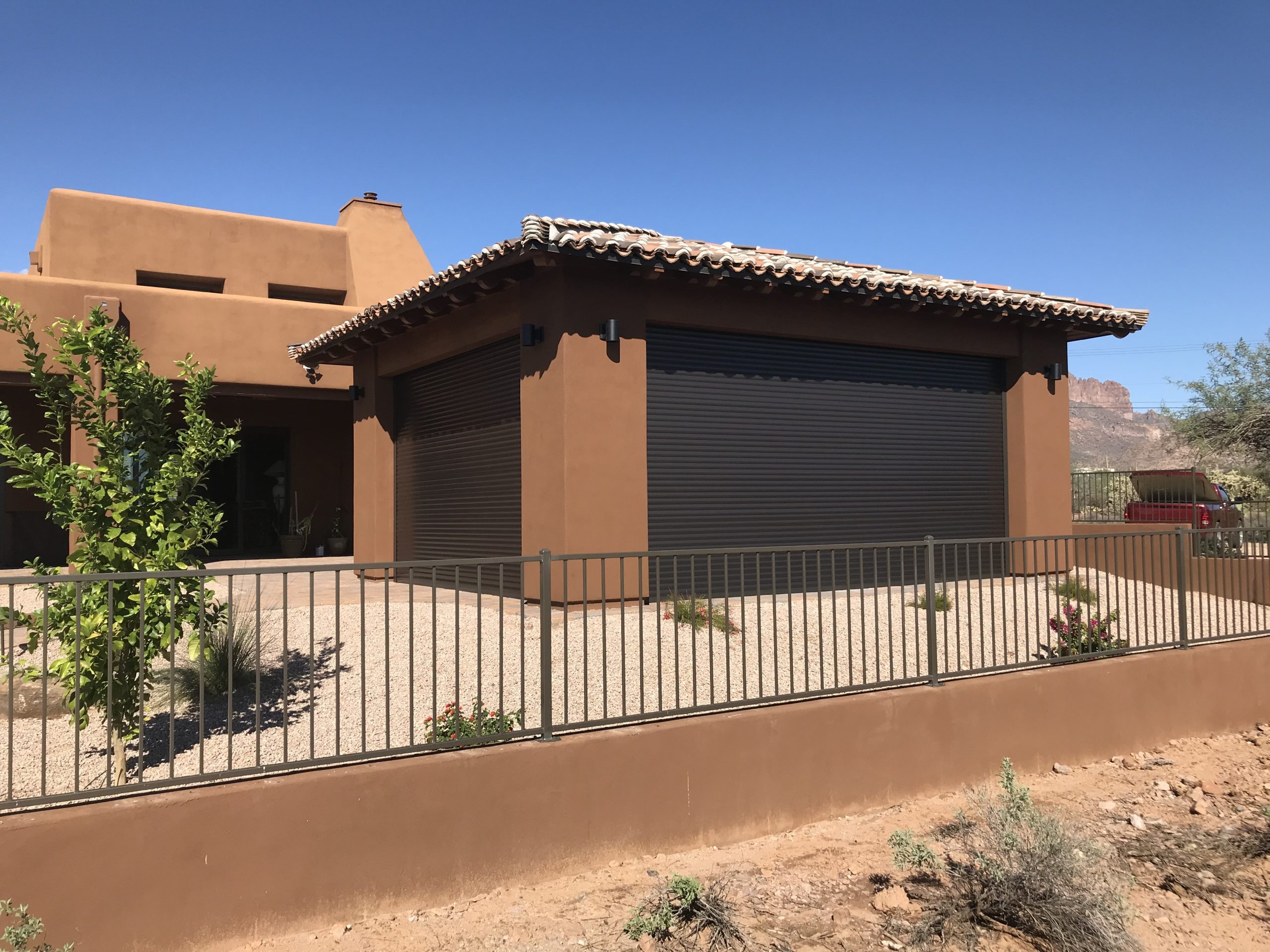 In-soffit rolling shutter installation tucked into the roof overhang of a custom gazebo enclosure