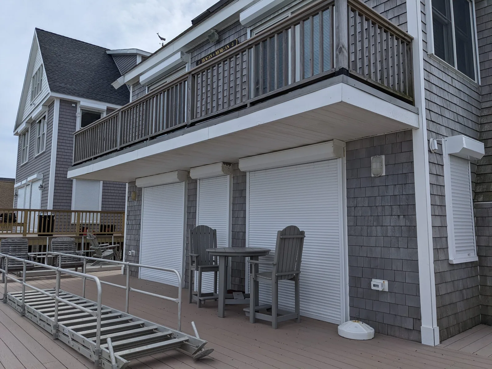 White motorized rolling security shutter installed over a window