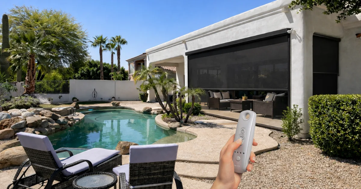 Homeowner lowering a patio screen by remote beside a backyard pool in Phoenix