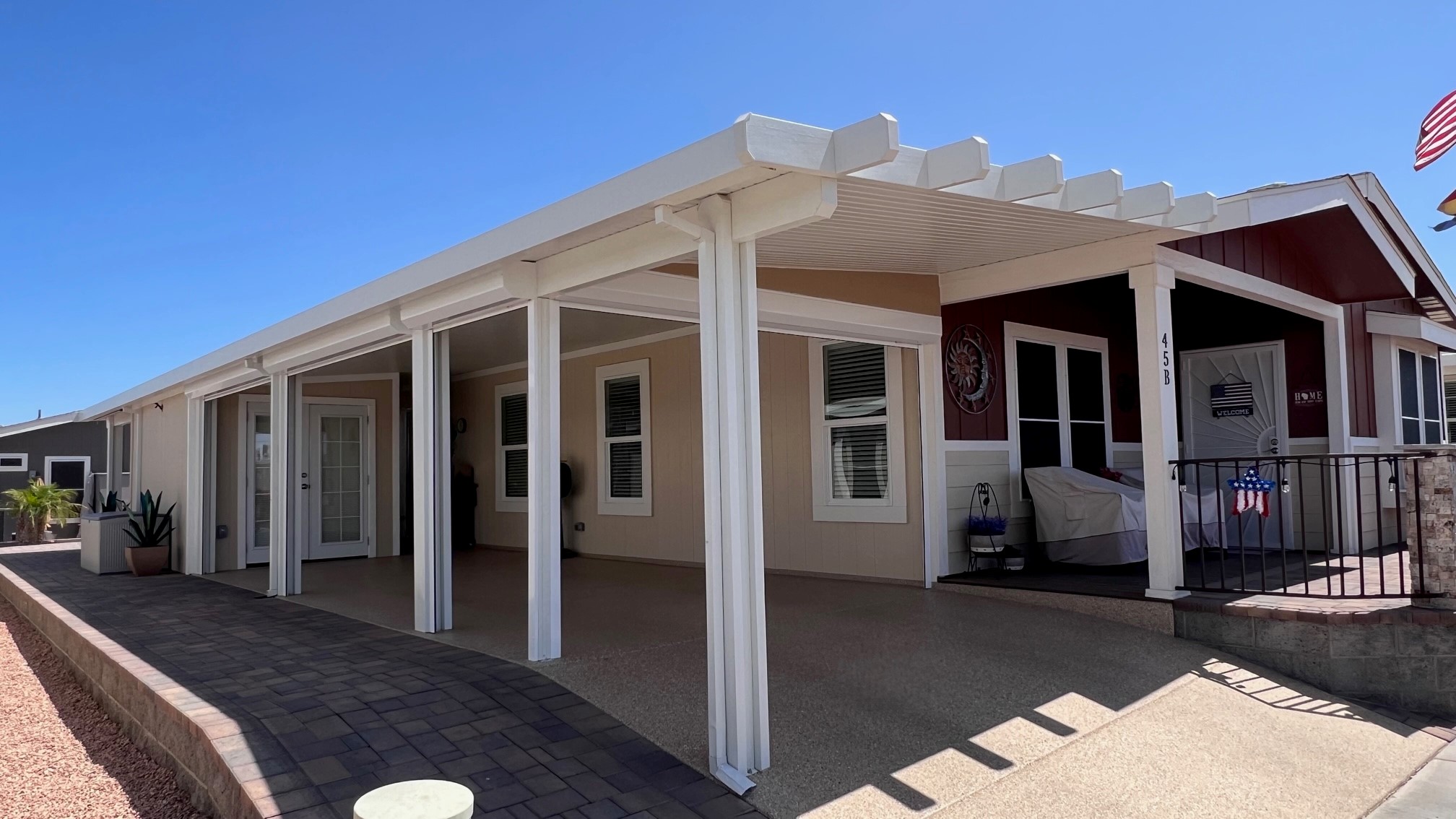 Rolling shutters rolled up out of sight along a covered patio on a Metro Phoenix home, every opening left open