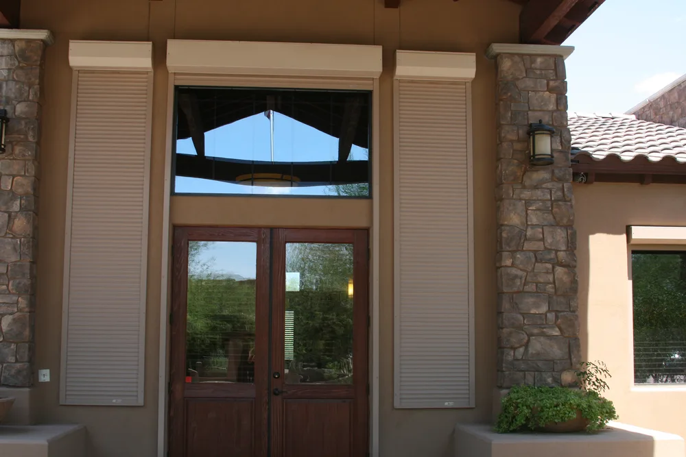 Rolling shutters flanking a home entry door