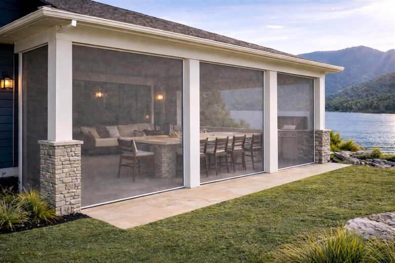 Rolling screens enclosing the patio of a lakeside vacation home