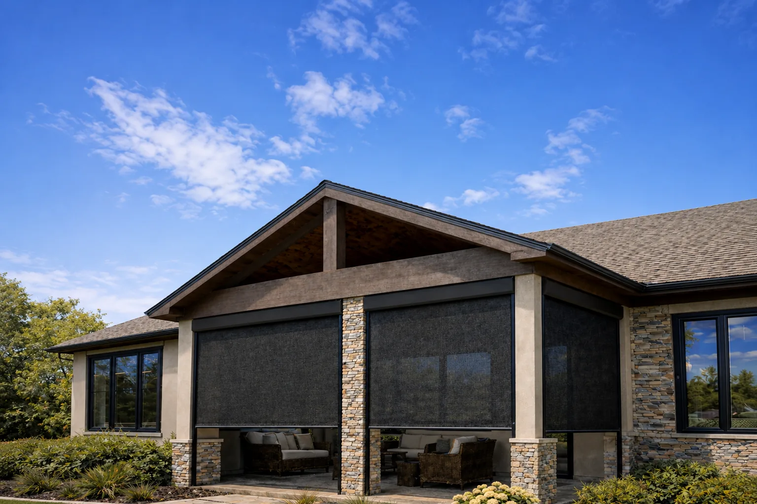 Screened porch with dark rolling screens enclosing an outdoor living room on a Metro Phoenix home