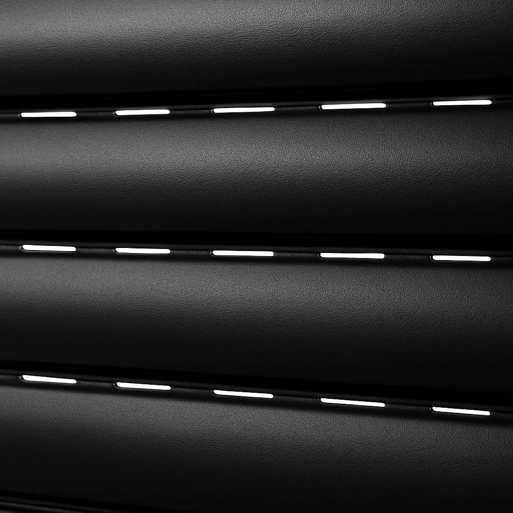 Close detail of black rolling shutter slats with daylight showing through the vent slots between them