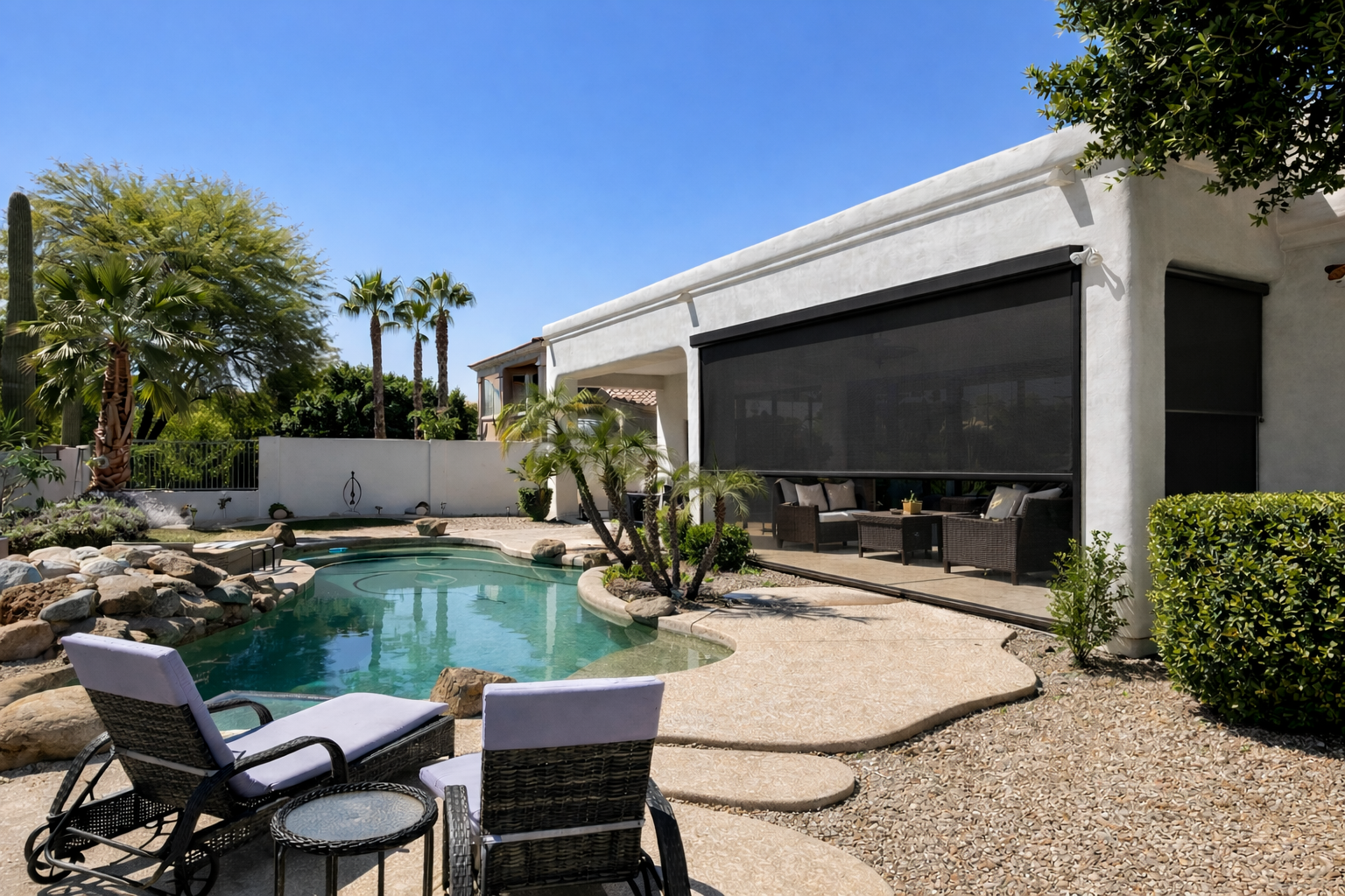 Solar-powered motorized rolling screens shading a covered patio far from existing power