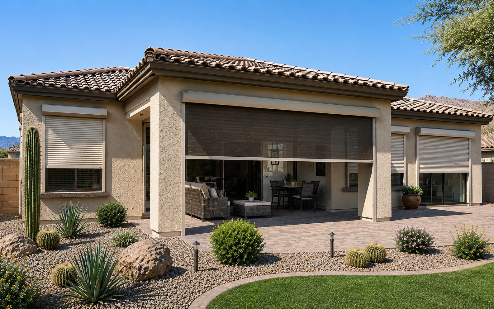 Stucco desert home with rolling shutters on the windows and a rolling screen lowered across the covered patio, each fitted to its own opening